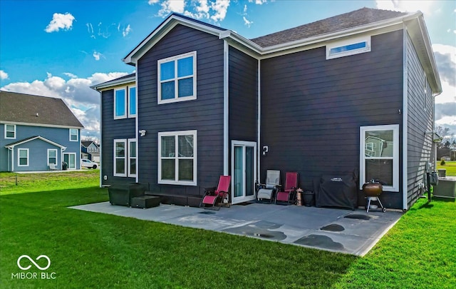 back of house featuring a yard and a patio area