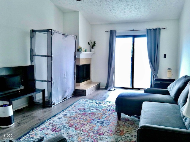 living room with hardwood / wood-style floors and a textured ceiling