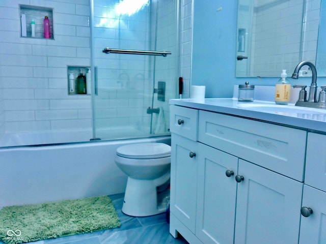 full bathroom with combined bath / shower with glass door, vanity, and toilet