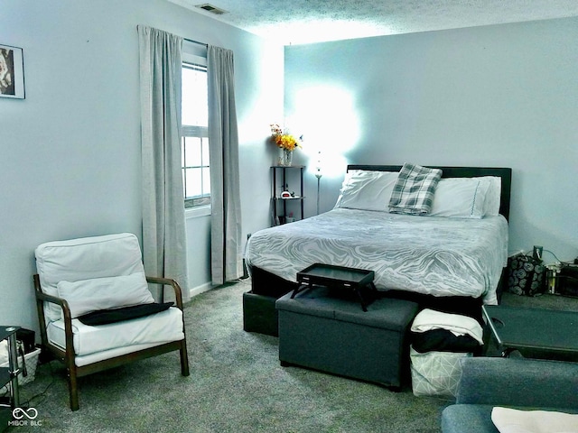 bedroom featuring light colored carpet and a textured ceiling