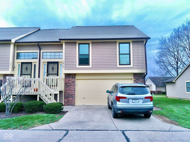 view of front of property with a front lawn and a garage