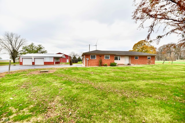 view of front facade featuring a garage, a front lawn, and an outdoor structure