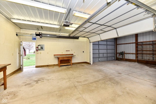 garage featuring electric panel, a garage door opener, and a carport