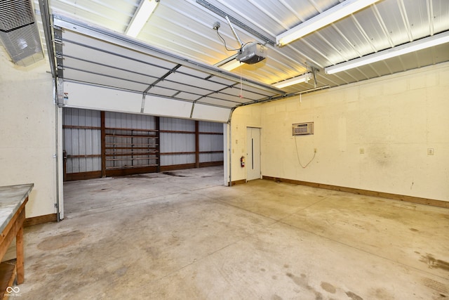 garage with a wall unit AC and a garage door opener