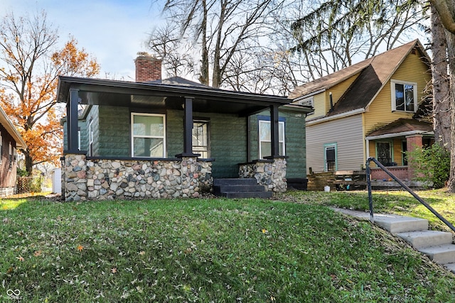 view of front of house with a porch and a front lawn