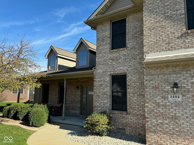 view of exterior entry with a porch