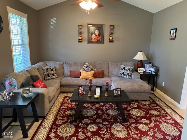 living room with ceiling fan and lofted ceiling