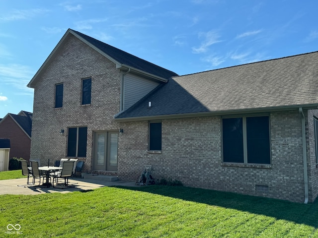 rear view of property featuring a yard and a patio