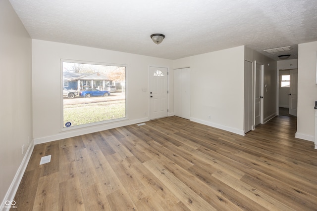 interior space featuring a textured ceiling and hardwood / wood-style flooring