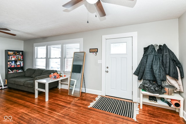 foyer entrance featuring dark wood-type flooring and a textured ceiling