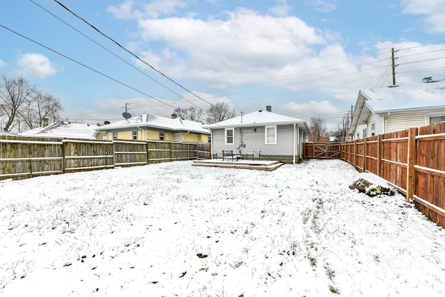 snow covered property with a wooden deck