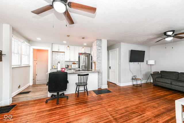 living room with dark hardwood / wood-style floors and a textured ceiling