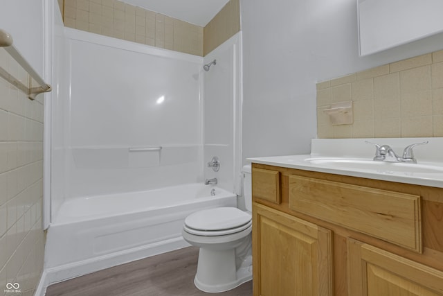 full bathroom featuring shower / bath combination, toilet, vanity, tile walls, and hardwood / wood-style flooring