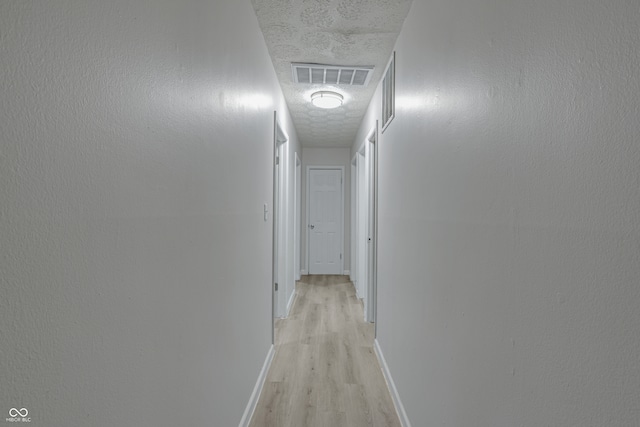 corridor with light hardwood / wood-style floors