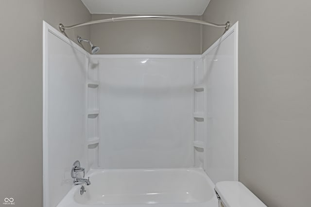 bathroom with shower / tub combination and toilet