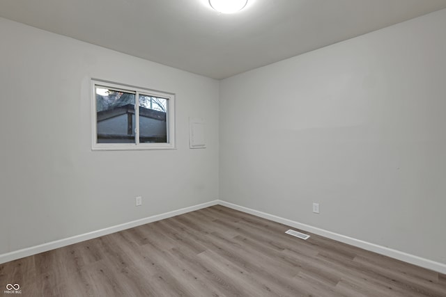 unfurnished room with light wood-type flooring