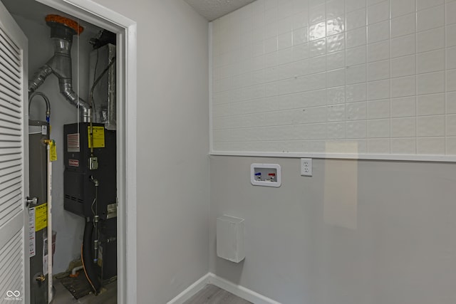 laundry room with washer hookup and hardwood / wood-style flooring