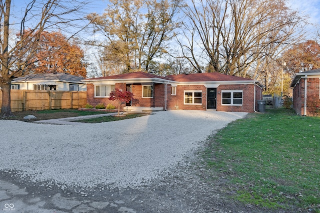 ranch-style house featuring a front lawn