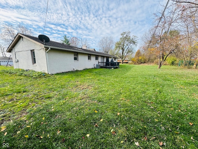 view of yard featuring central AC and a wooden deck