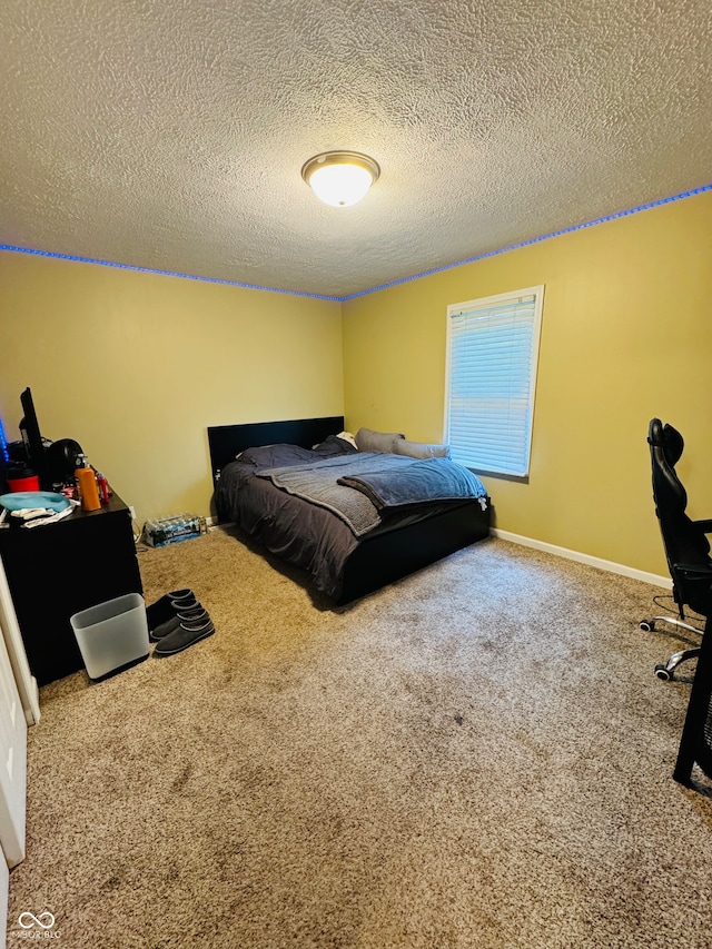 carpeted bedroom featuring a textured ceiling