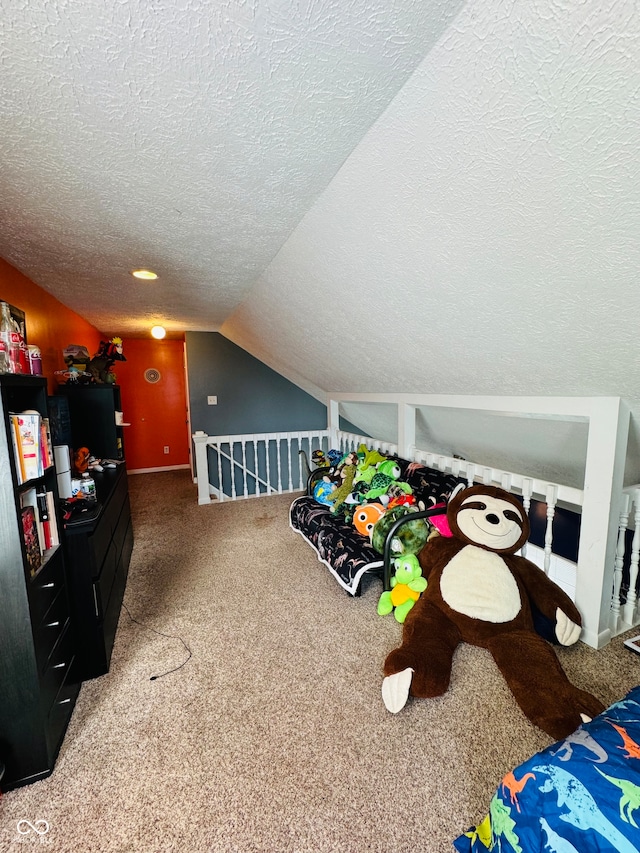 carpeted bedroom featuring lofted ceiling and a textured ceiling