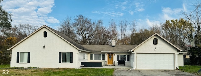 view of front facade with a garage and a front lawn