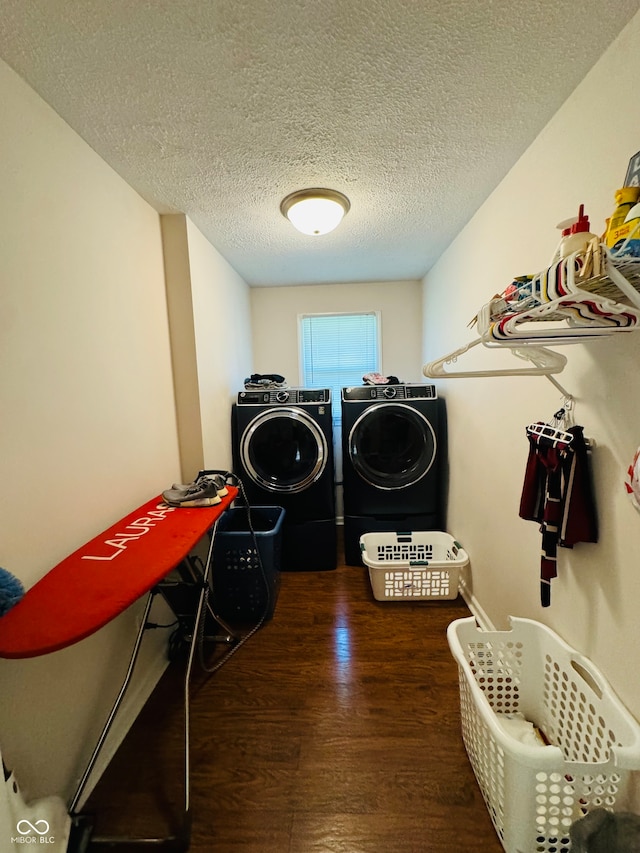 laundry area featuring separate washer and dryer, a textured ceiling, and dark hardwood / wood-style floors