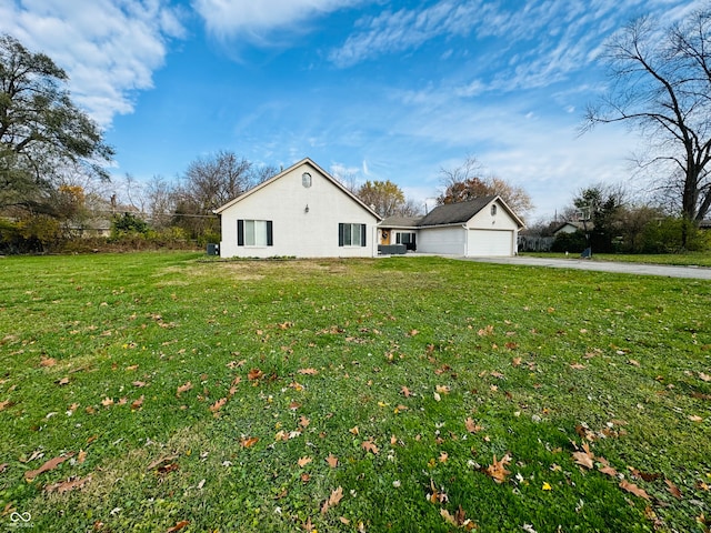 view of side of home with a lawn and a garage