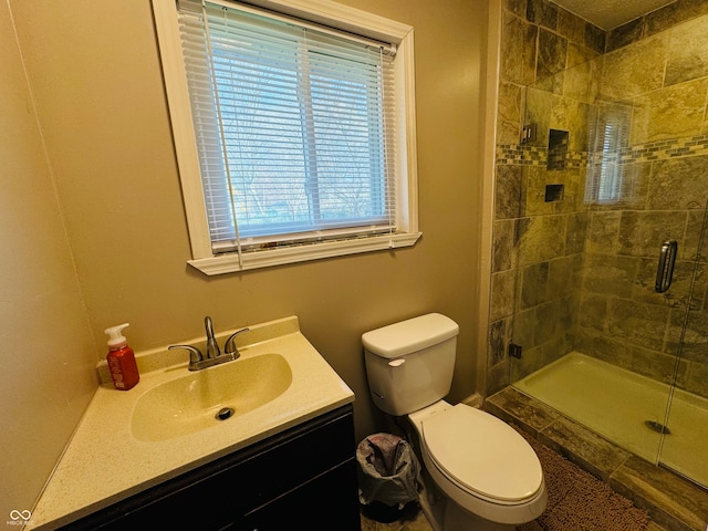 bathroom with vanity, an enclosed shower, and toilet