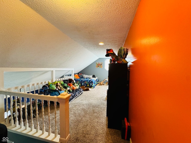 game room with carpet flooring, lofted ceiling, and a textured ceiling