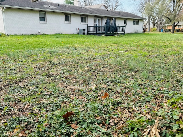 view of yard featuring a deck and central AC