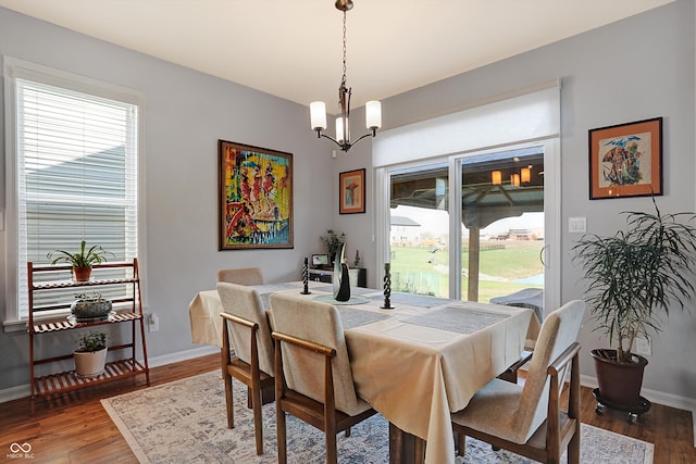 dining room featuring hardwood / wood-style floors, plenty of natural light, and a notable chandelier