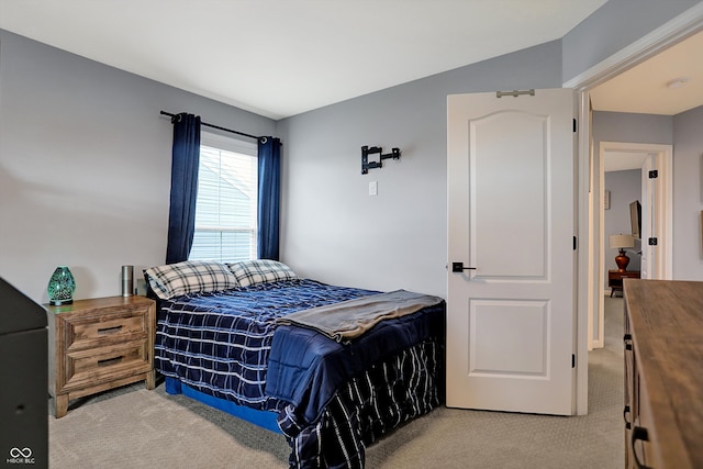 carpeted bedroom with lofted ceiling