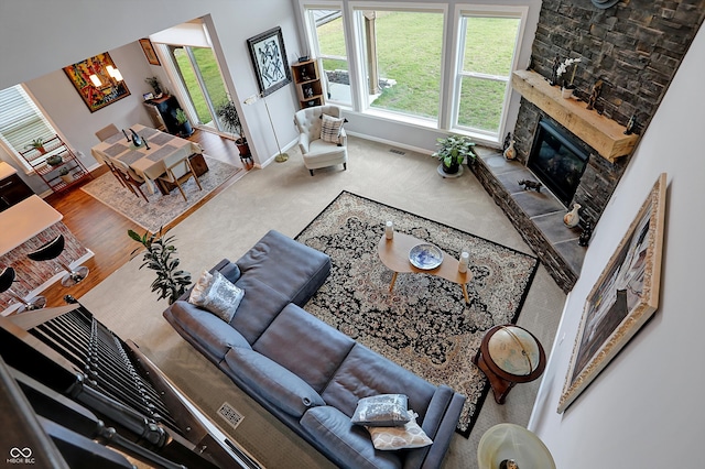 living room featuring hardwood / wood-style flooring and a stone fireplace