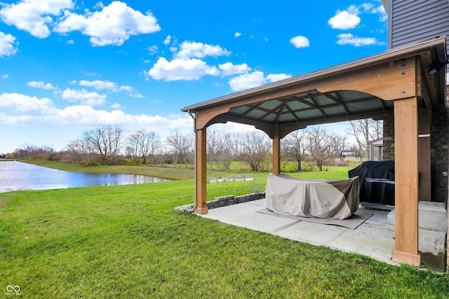 view of yard with a gazebo, a water view, and a patio area