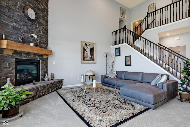 living room with carpet flooring, a fireplace, and a high ceiling