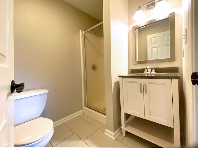 bathroom featuring vanity, toilet, and walk in shower