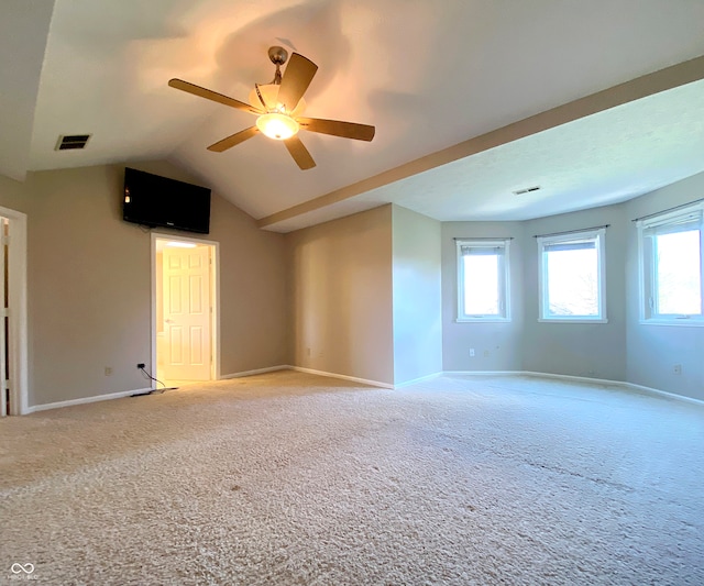 carpeted spare room with vaulted ceiling and ceiling fan