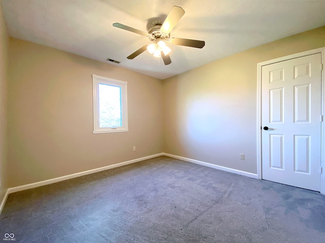 carpeted empty room with ceiling fan