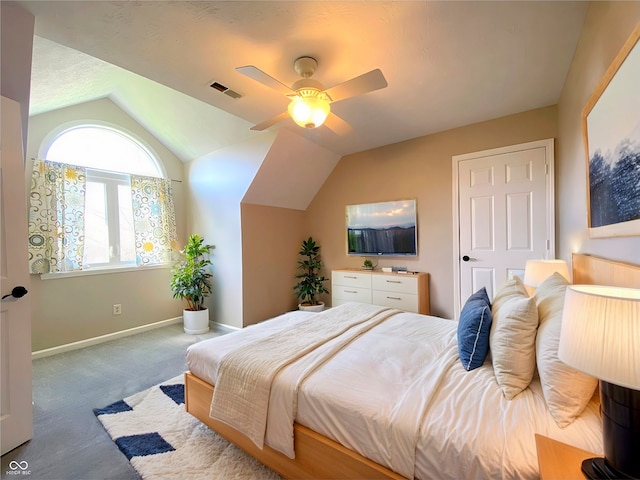 bedroom with lofted ceiling, ceiling fan, and carpet flooring