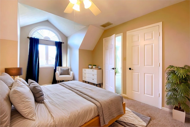 carpeted bedroom with ceiling fan and vaulted ceiling