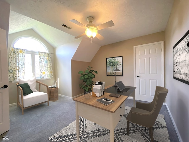 carpeted home office with ceiling fan, lofted ceiling, and a textured ceiling