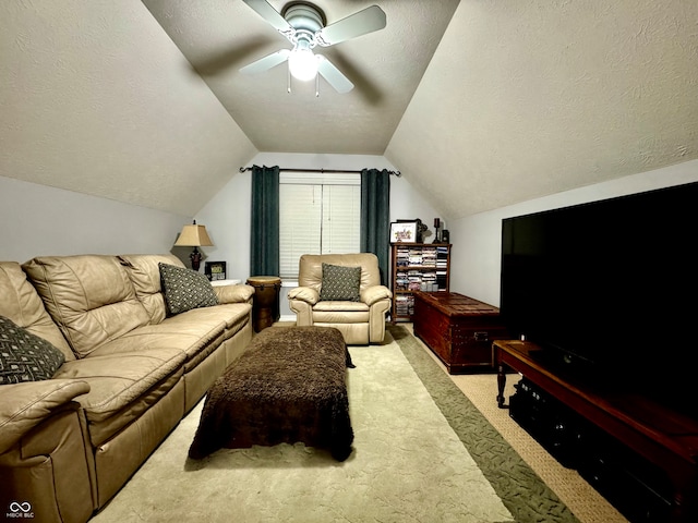 living room with ceiling fan, light colored carpet, a textured ceiling, and vaulted ceiling