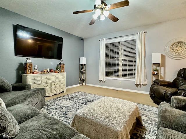 carpeted living room with ceiling fan