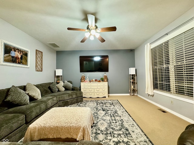 carpeted living room with ceiling fan