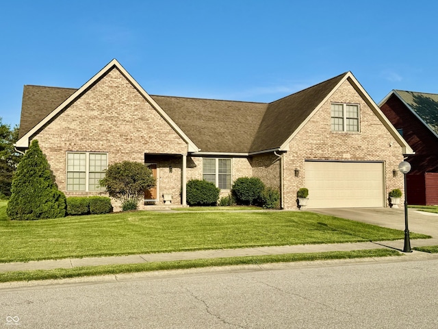 6998 Meredith Dr, Seymour, IN 47274 - view of front of house with concrete driveway, brick siding, and a garage