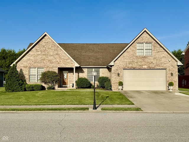 6998 Meredith Dr, Seymour, IN 47274 - traditional-style house featuring brick siding, driveway, a garage, a front lawn, and roof with shingles