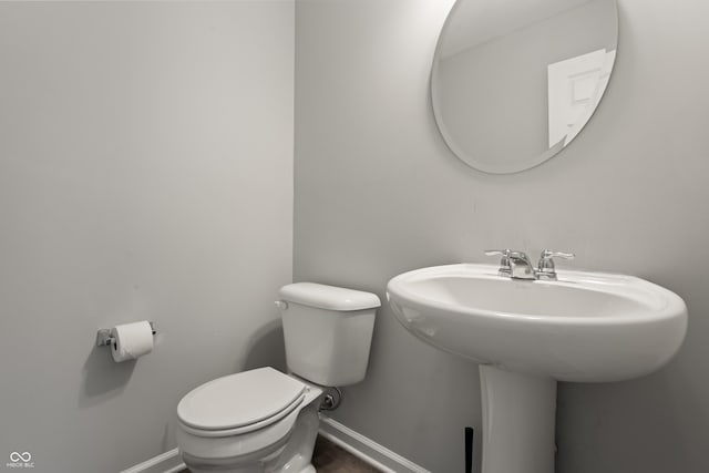10797 Walden Ln, Brownsburg, IN 46112 - bathroom featuring baseboards, toilet, and a sink
