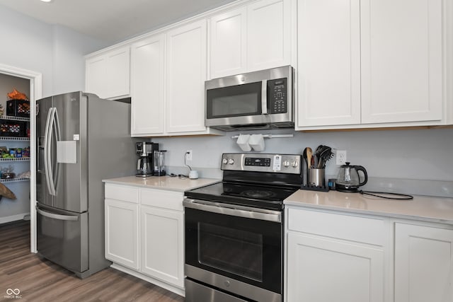 kitchen with white cabinetry, dark wood-type flooring, and stainless steel appliances