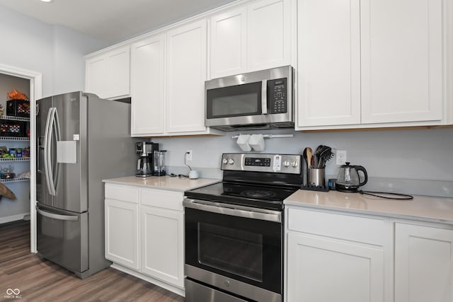 10797 Walden Ln, Brownsburg, IN 46112 - kitchen with appliances with stainless steel finishes, light wood-style floors, light countertops, and white cabinetry